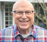 Bob Lonac in a blue, grey, and red flannel shirt.