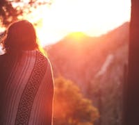 woman wrapped in a sunrise