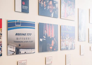 A gallery wall of various images celebrating Boeing's 50 years in China.