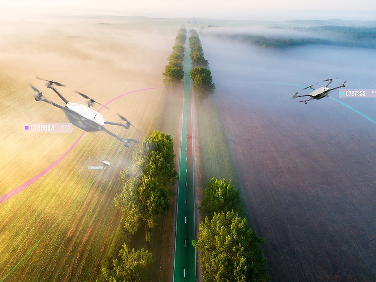 Skygrid concept of drones flying above country road