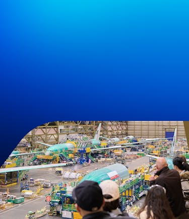 Tour guests overlook the Boeing Everett factory floor from our balcony as planes move through the flight line for assembly.