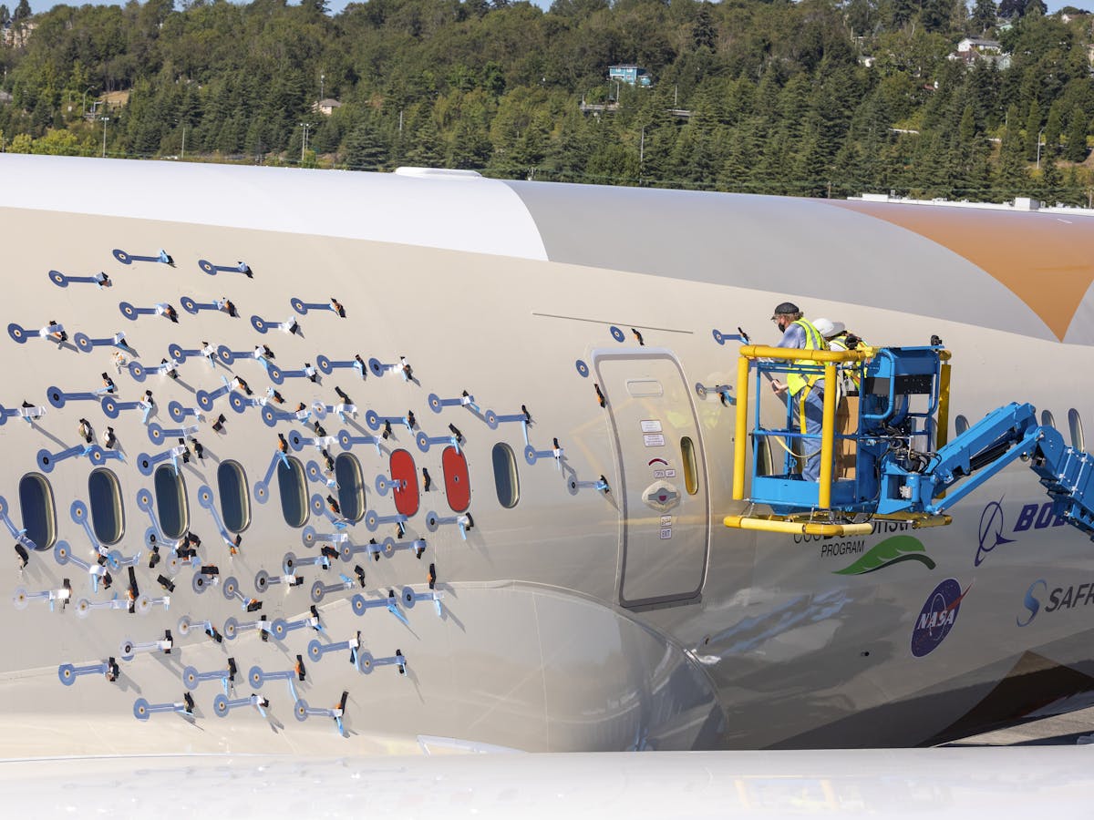 Microphone sensors being installed with silver taping at Boeing Field, Seattle. 