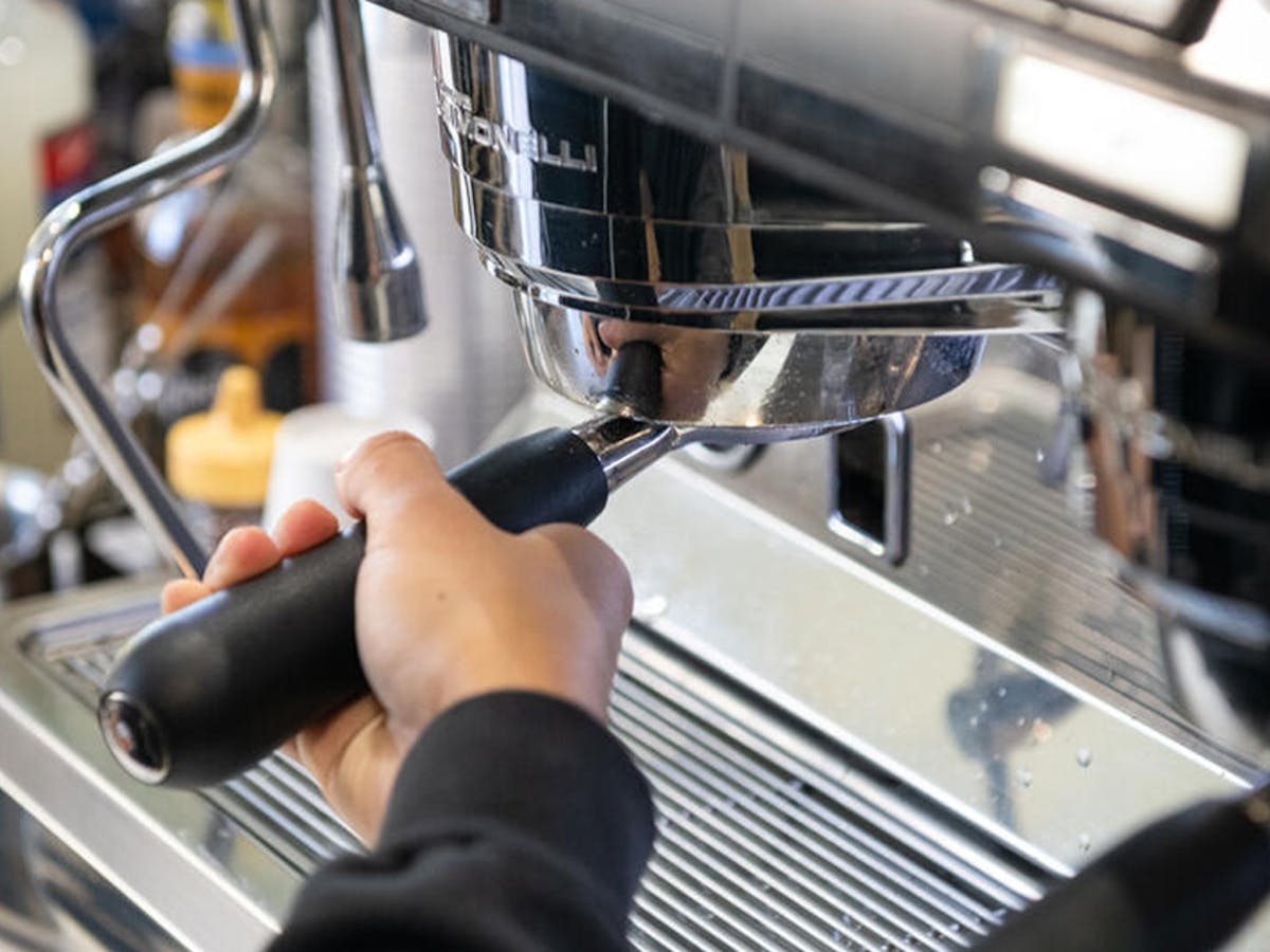 A barista making coffee with one of our Café's espresso machines.