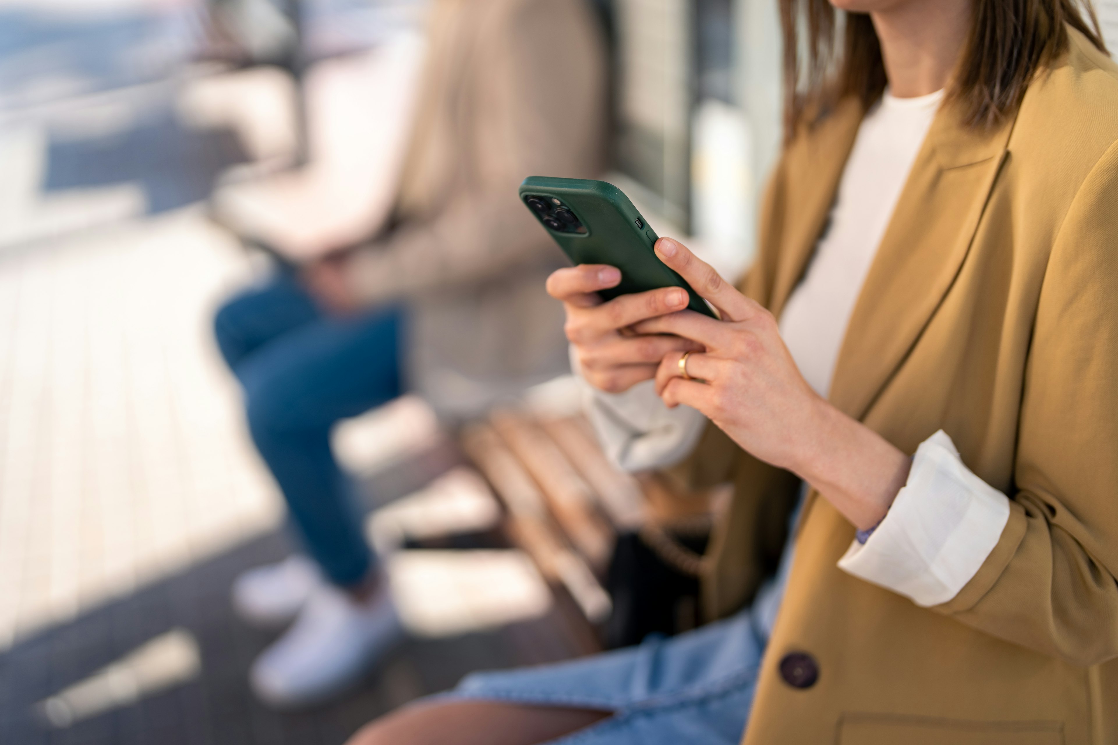 Woman using phone at bus stop
