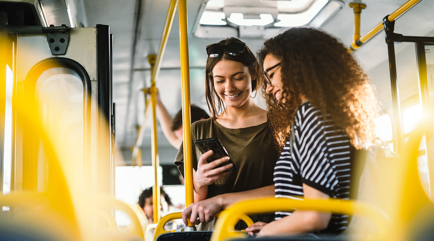 Woman using phone on the bus.