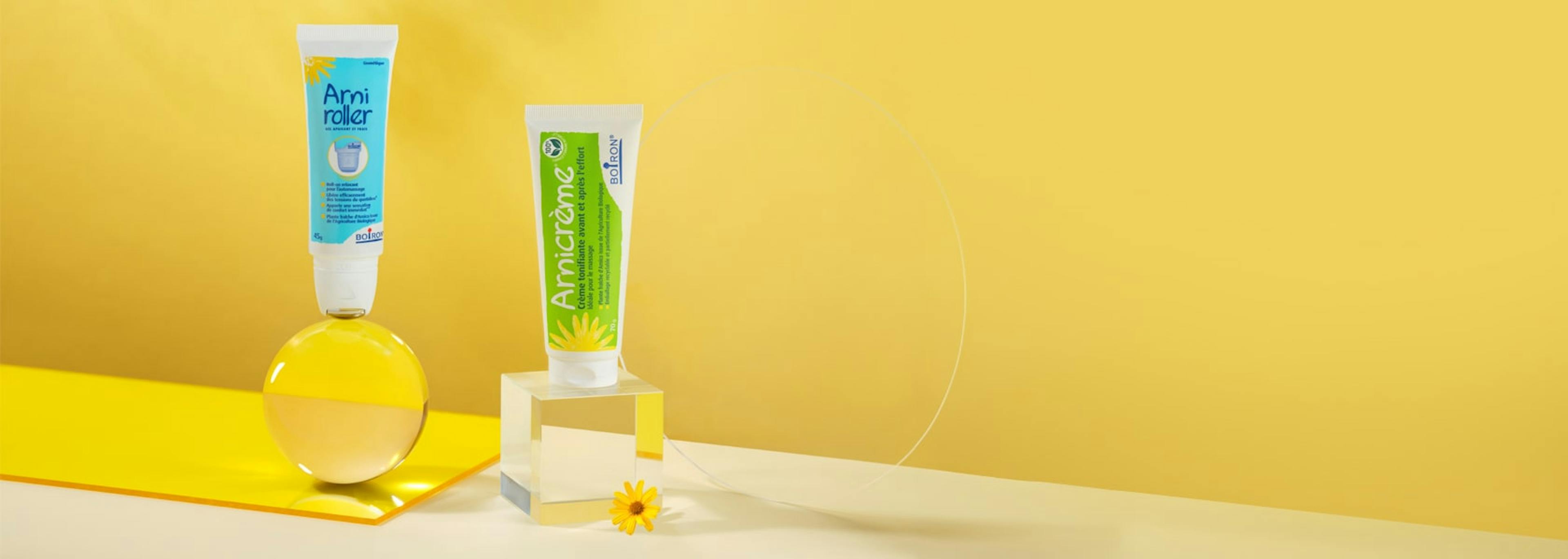 Gamme Arnica Boiron Arniroller et arnicrème sur fond jaune