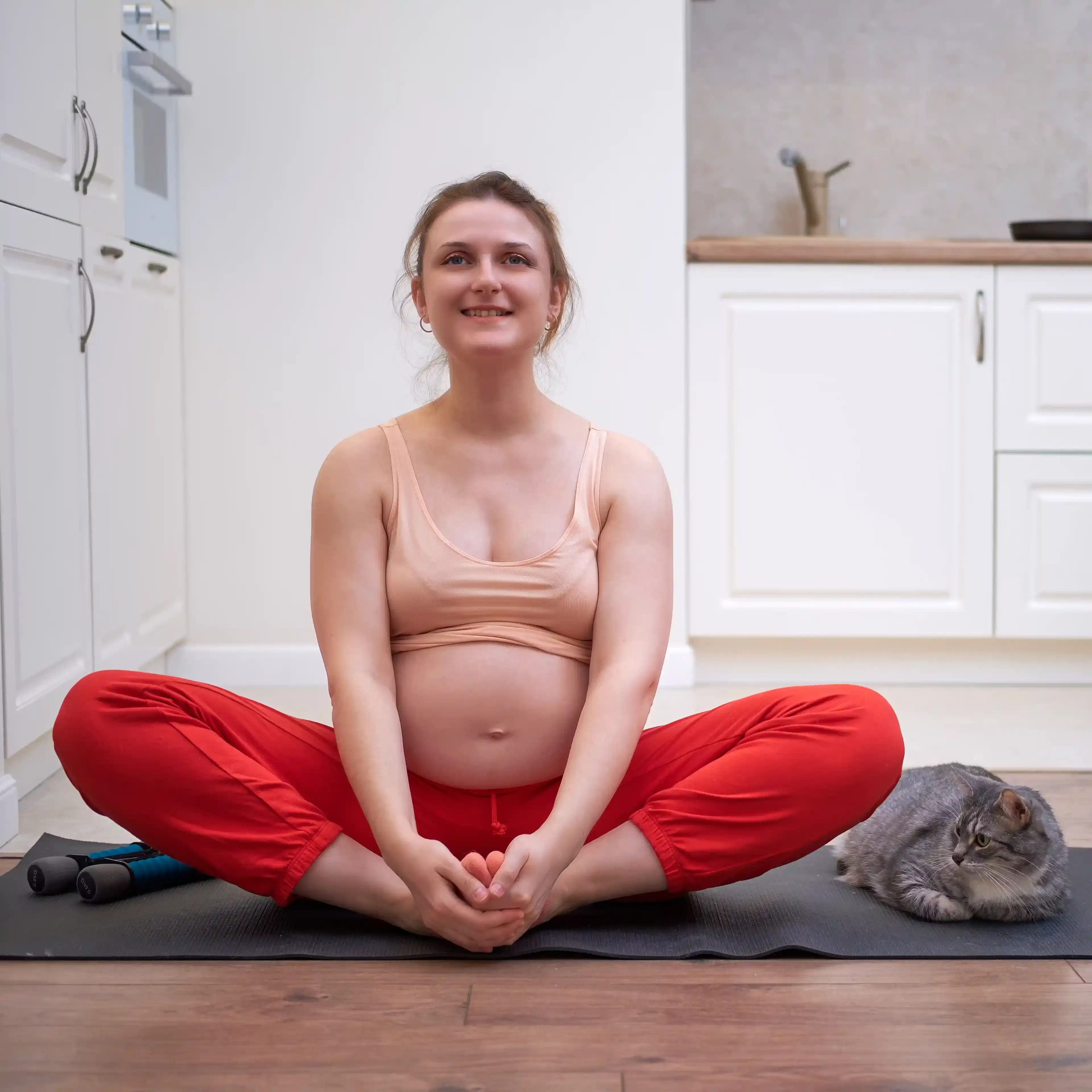 Zwangere vrouw in vlinder positie tijdens yoga