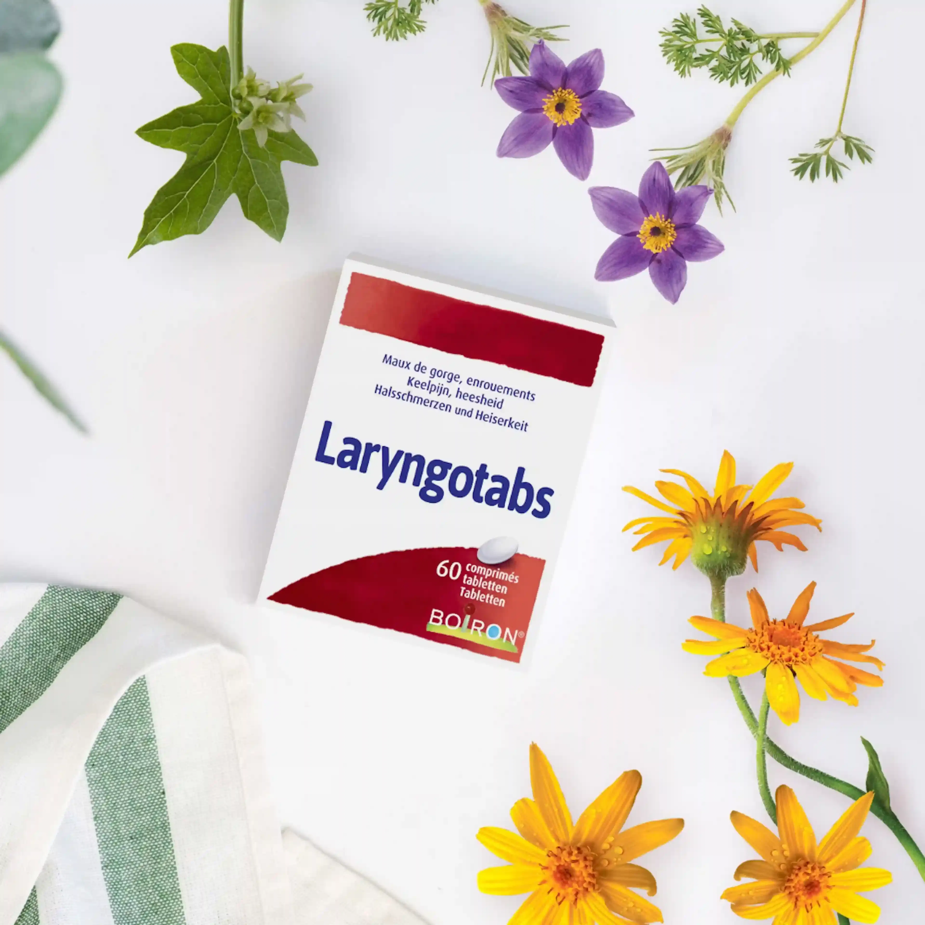 Boite Laryngotabs entourée de fleurs