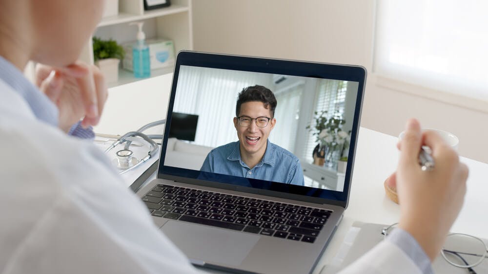 Online interview with male candidate using laptop