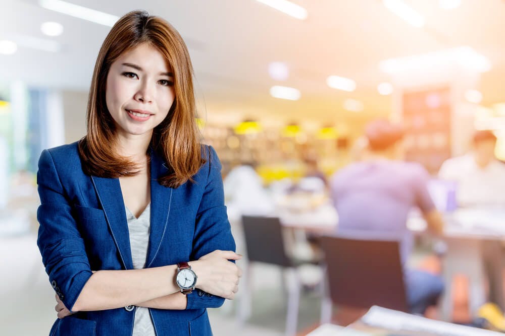 smiling female executive with office background