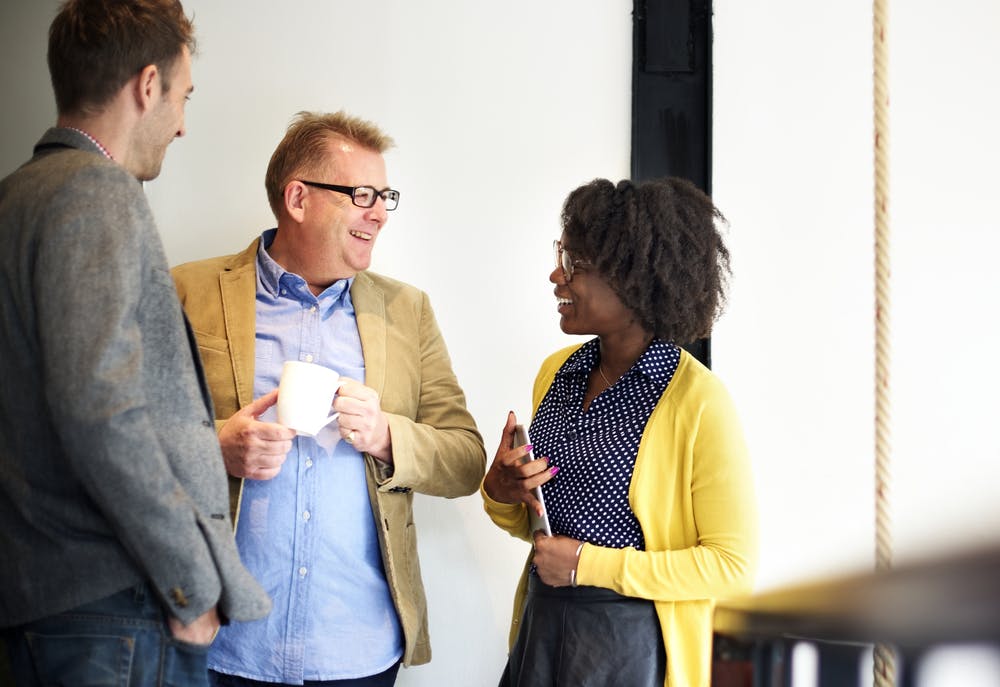 Employees enjoying the benefits of coaching using positive psychology