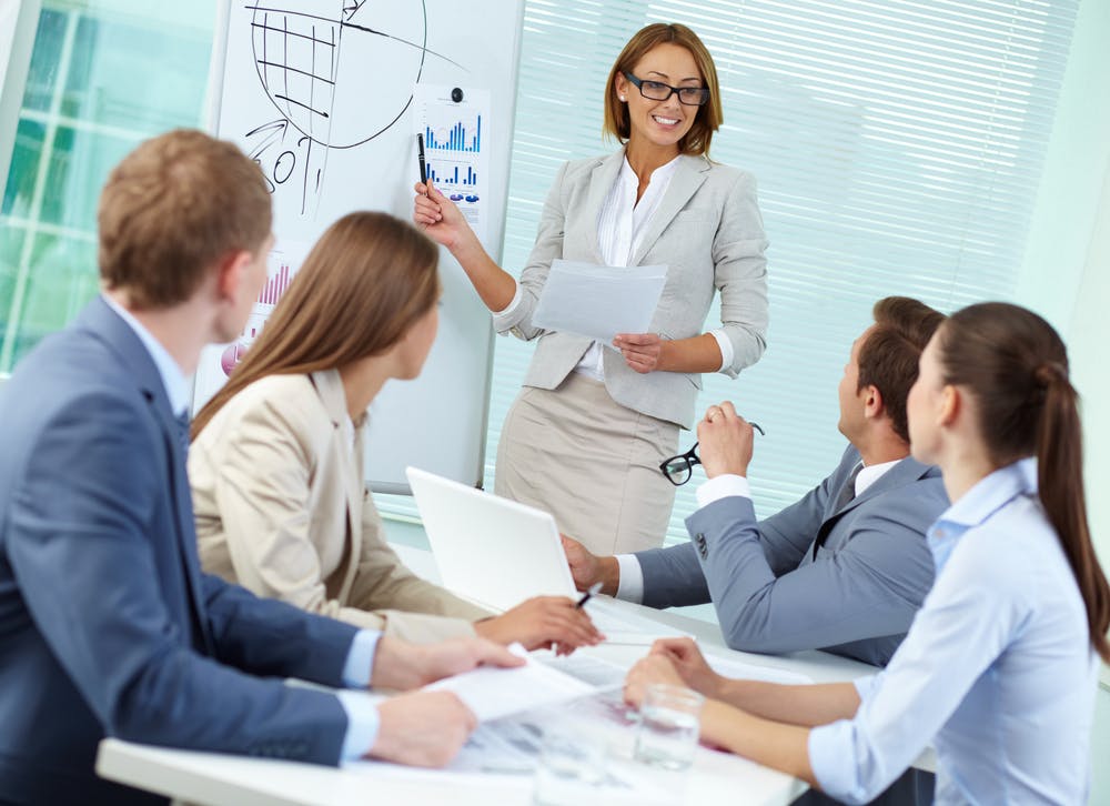 Confident female leader working with colleagues