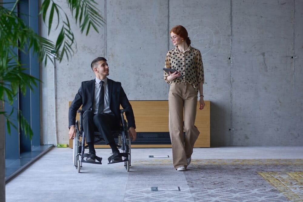 Man in wheelchair demonstrating resilience at work
