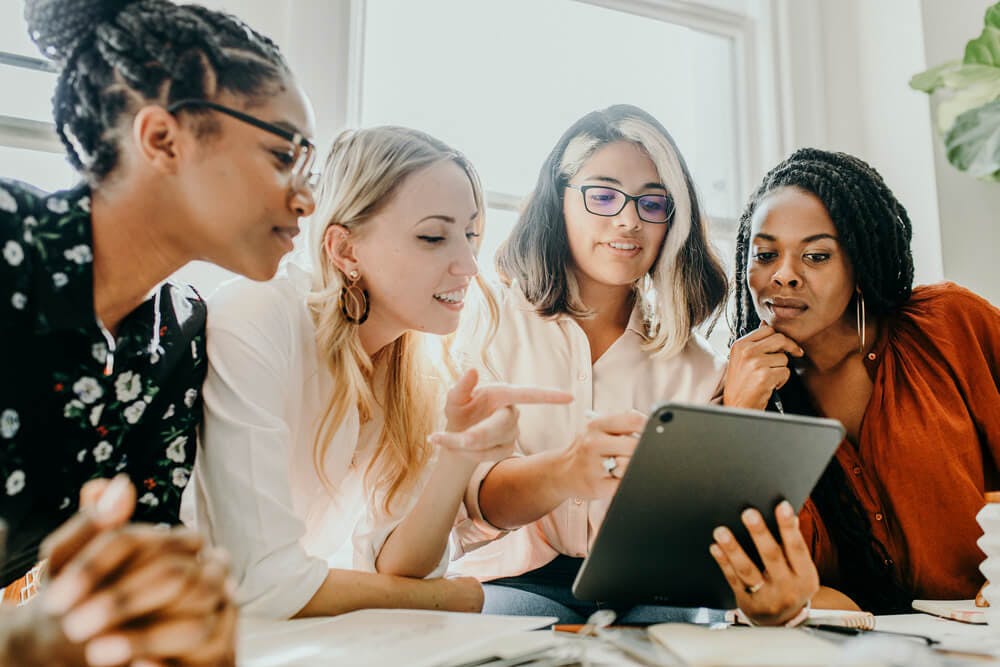 Female employees join together to work on a task