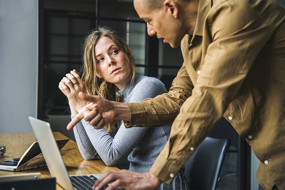 two employees in a heated conversation