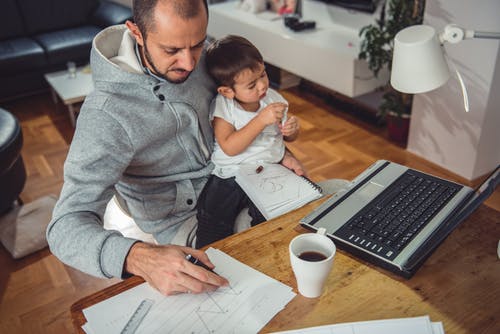 man and child with laptop