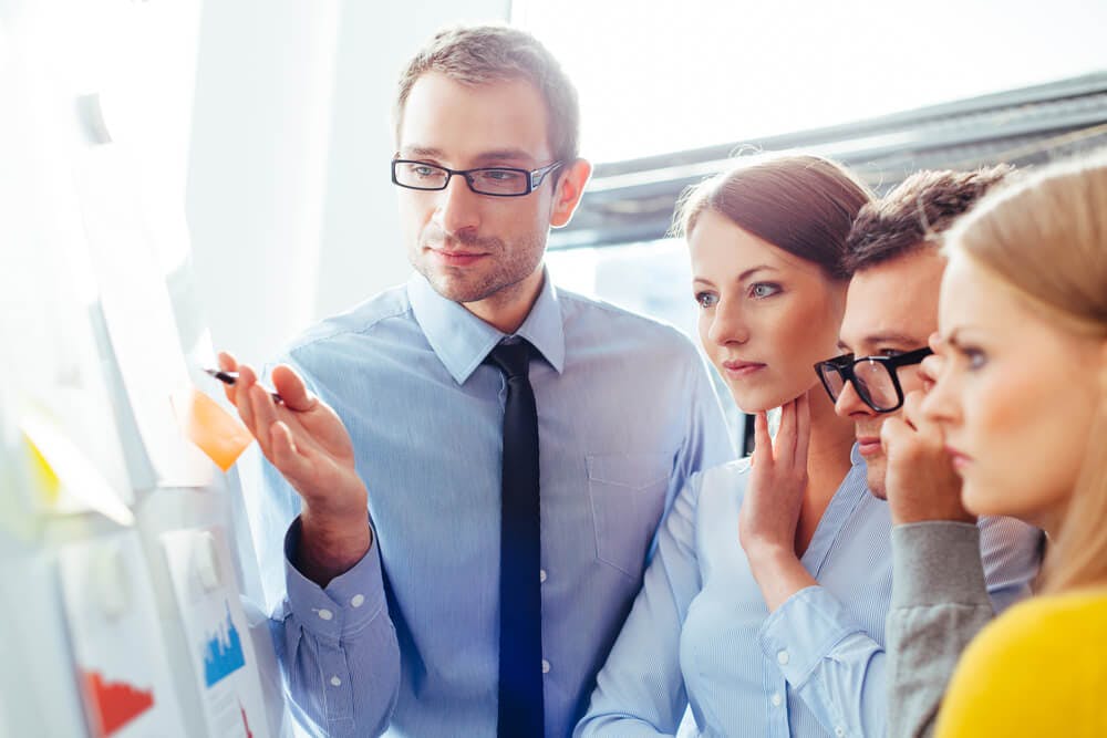 employees in a meeting with their supervisor