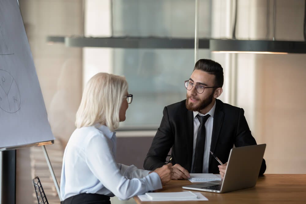 experienced female career coach talking to male coachee