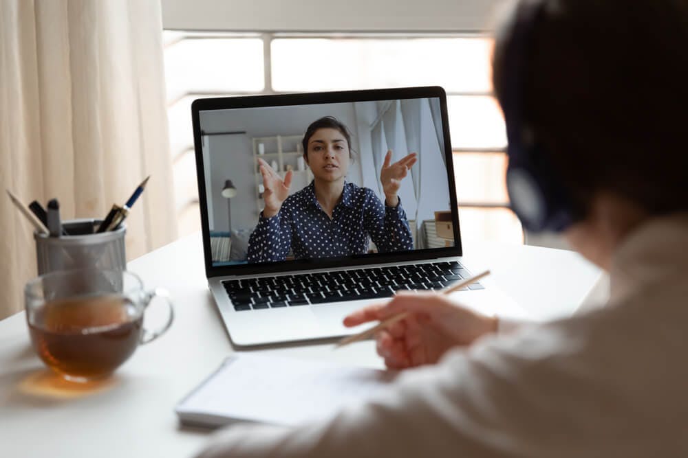 An external coach teaching an employee one on one during a virtual call