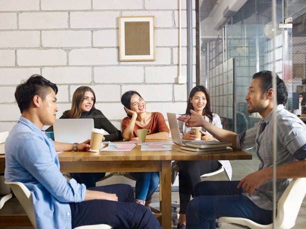 diverse colleagues smiling while brainstorming