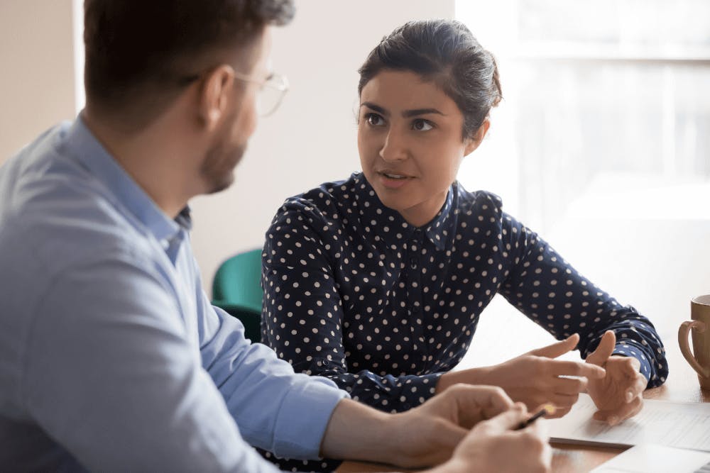 A man talking to a female wealth manager