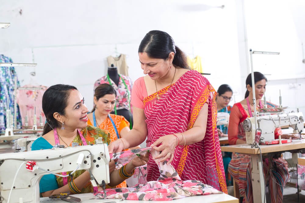 women textile workers sewing garment