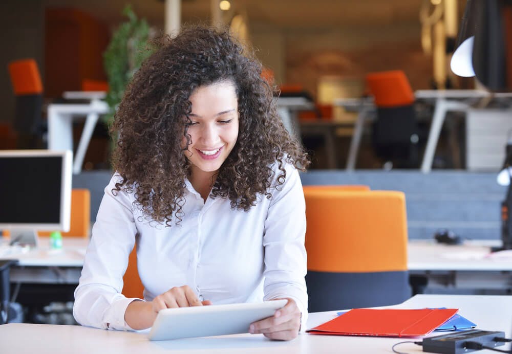 Lady using a tablet for coaching services