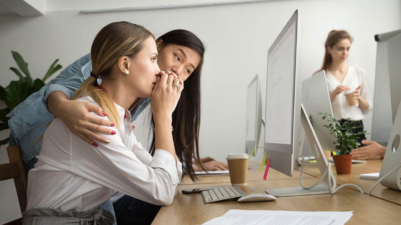 woman coaching another woman about work