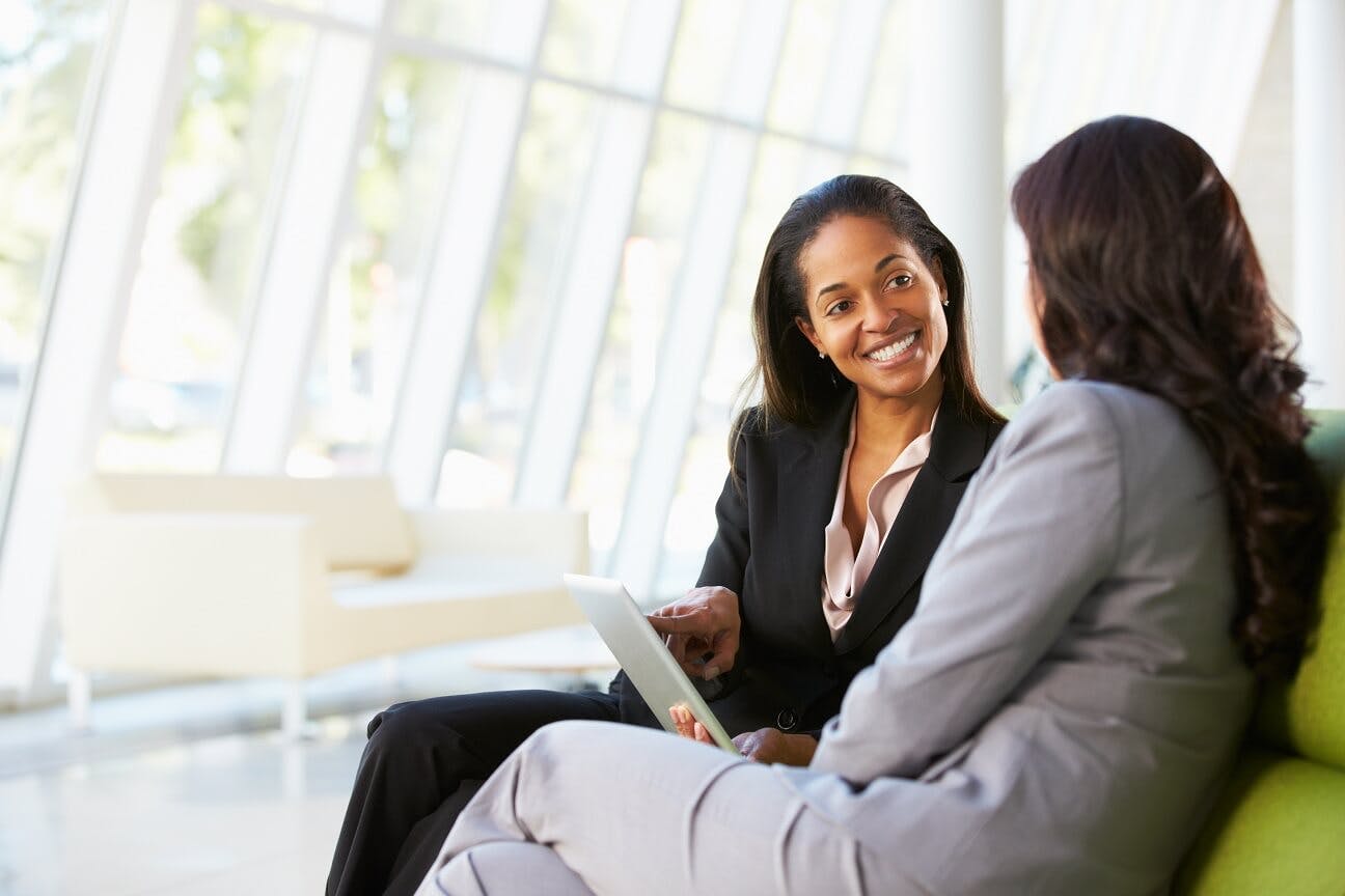 two ladies talking in couch