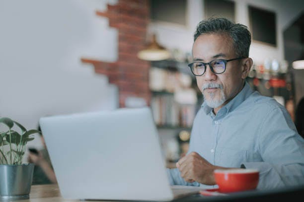 Man looking into his computer