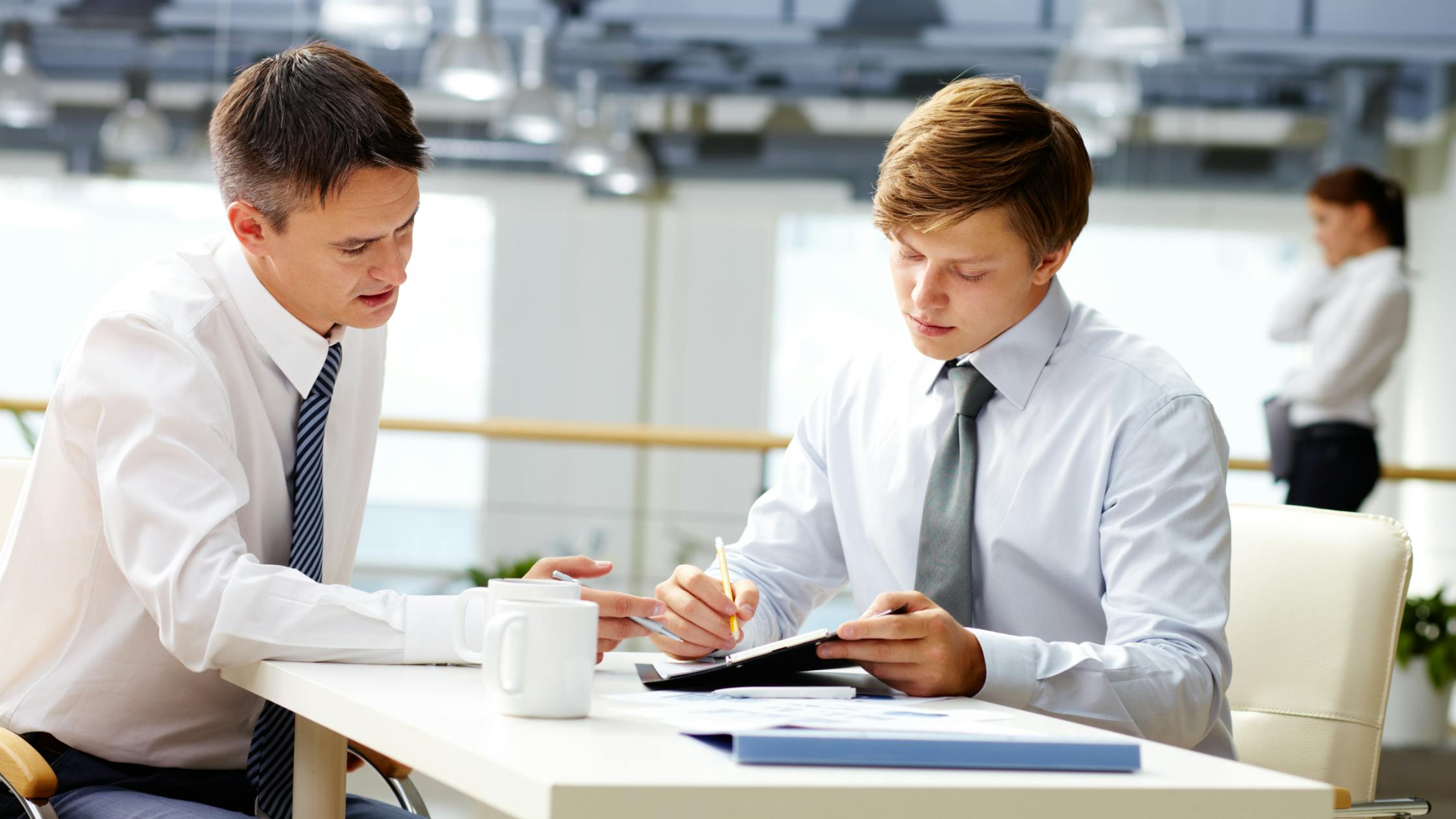 Two professionals having a discussion in the workplace