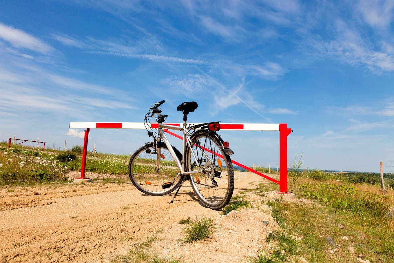 bicycle parked in front of a road stop in a desert