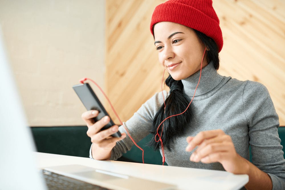 Gen Z employee listening to music while working from home