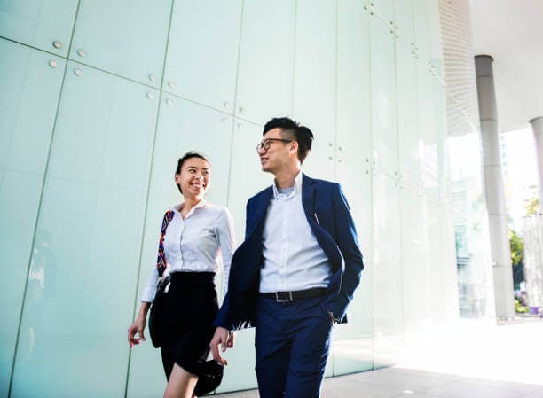 a woman looking to a man walking