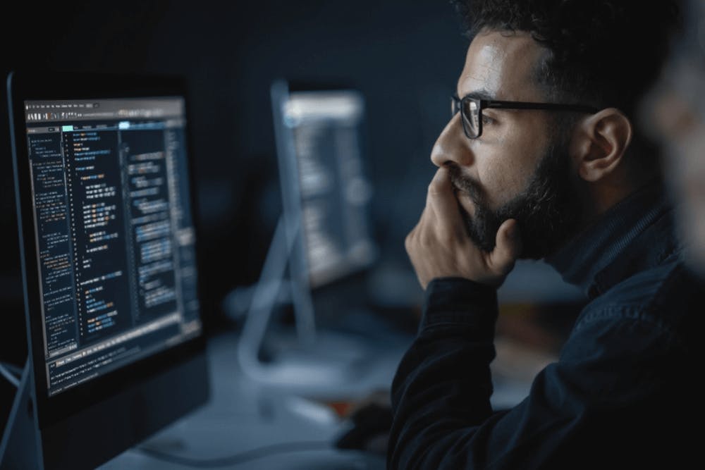 An employee working on his desk and learning new skills