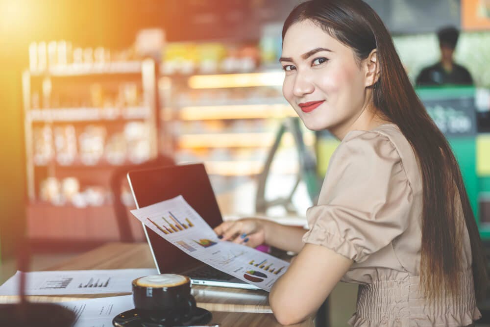 smiling female employee holding report