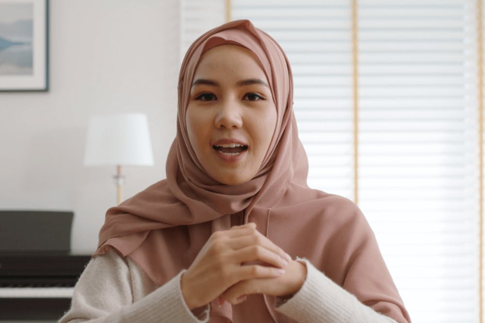 Gen Z Islamic woman on a work video call in the comfort of her home 