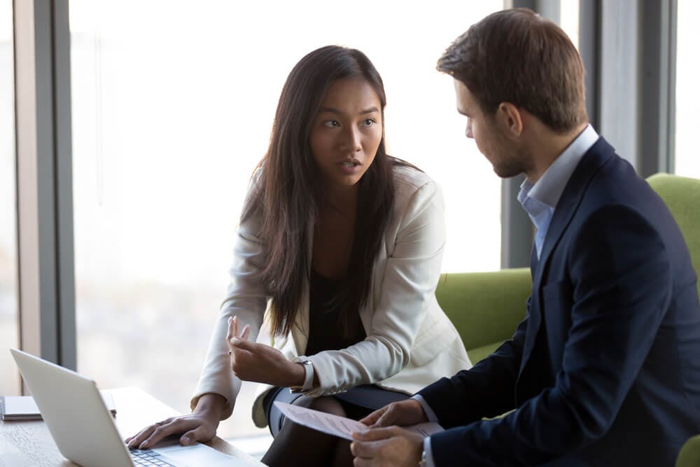 A Female coach helping a male coachee with feelings of uncertainty