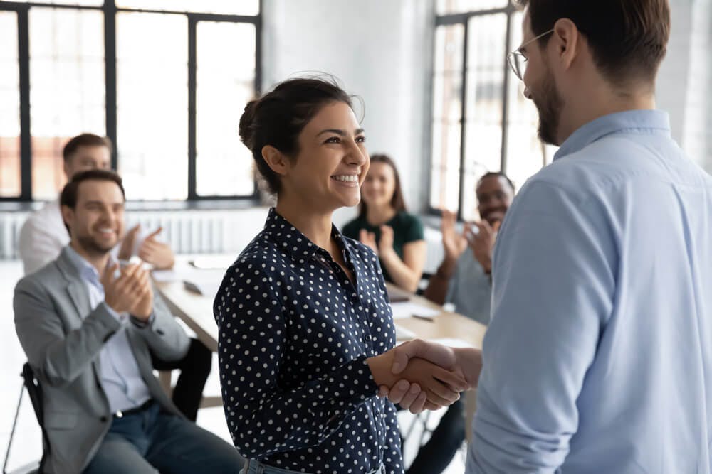 proud young female employee getting a promotion