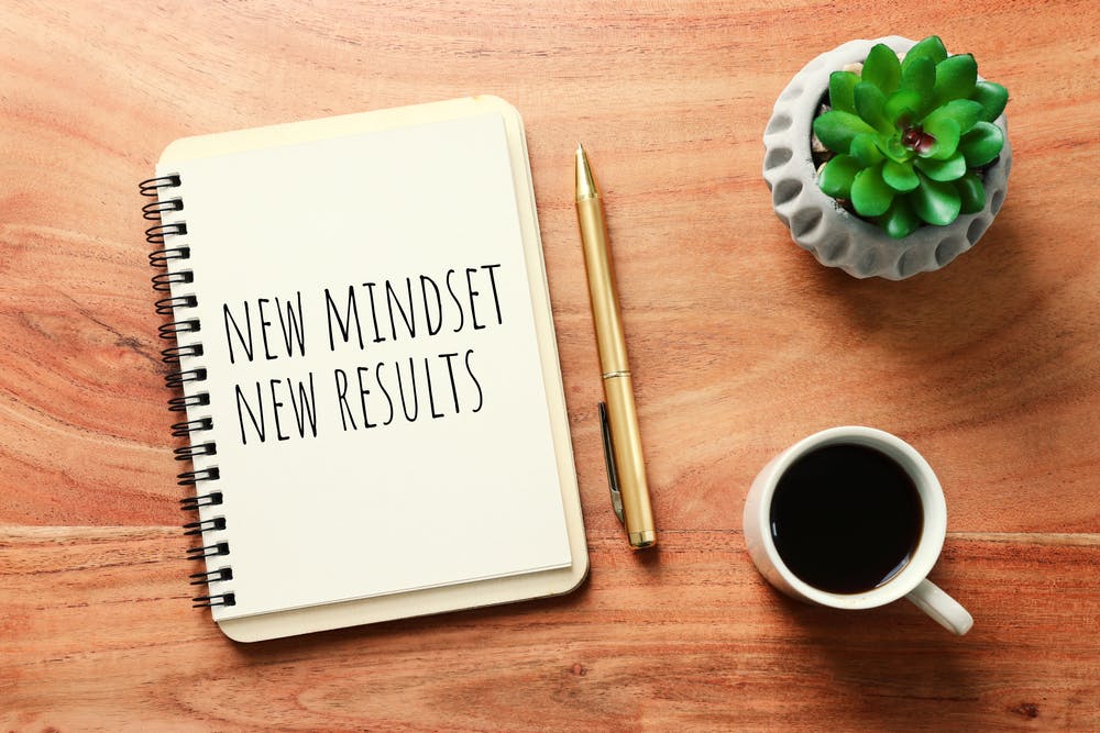 Notebook page that says new mindset new results as proof of effective coaching