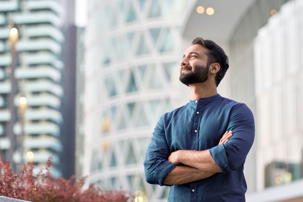 A man standing looking away and contemplating his goals