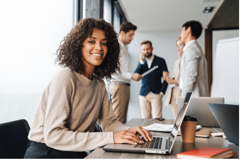 An African American first time manager working with colleagues