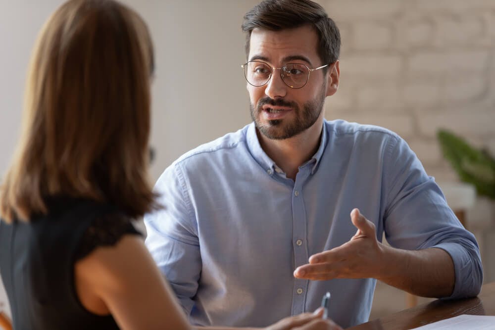 Male coach working with a female coachee who went through a psychometric assessment