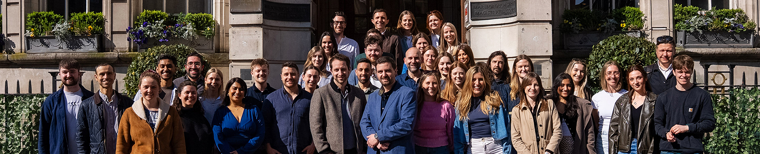 Group of Boldspace employees smiling to camera.