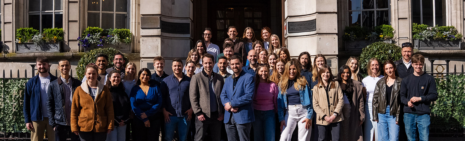 Group of Boldspace employees smiling to camera.