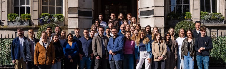 Group of Boldspace employees smiling to camera.