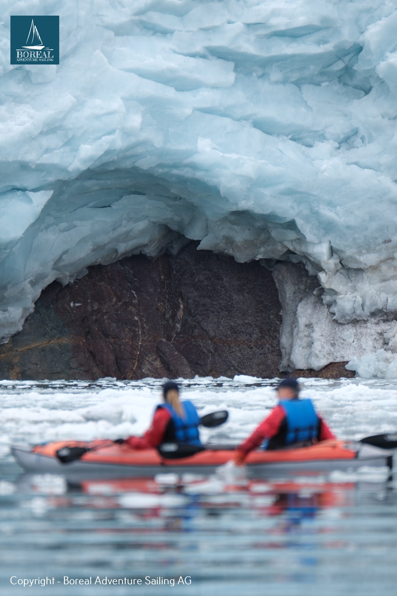 Sail & Kayak, Svalbard: two kayakers in a tandem kayak before a glacier ice cave