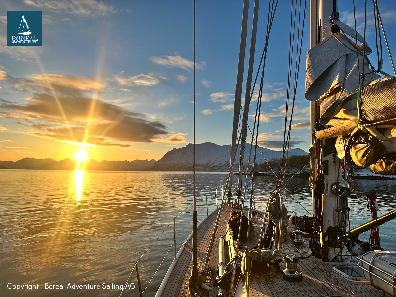 Ski & Sail, Lyngen Alps: sun setting over the fjord, seen from the yacht's deck