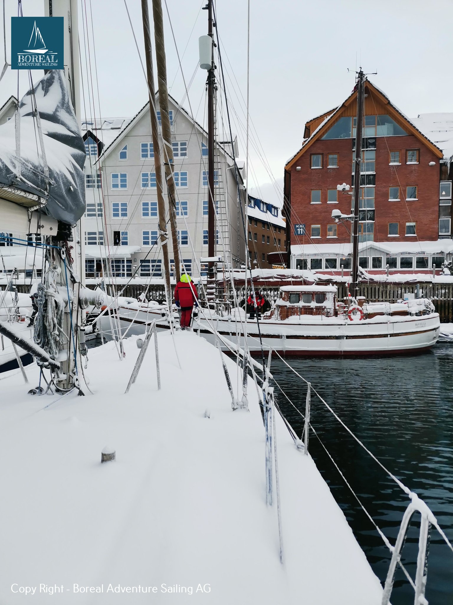 Offshore Sailing: snow-covered deck of the yacht moored in a Norwegian harbour