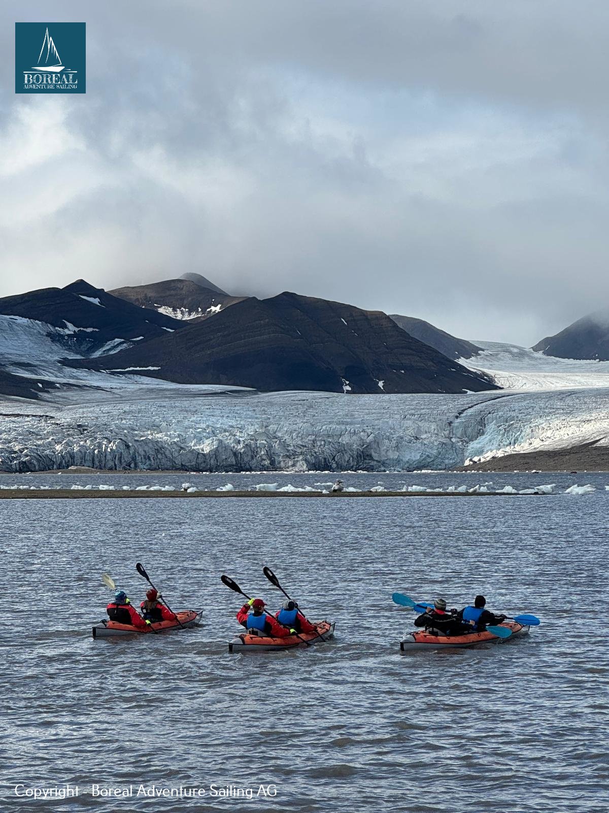 Sail & Kayak, Svalbard: three tandem kayaks paddling in front of a glacier and peaks